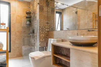 a bathroom with a sink and a toilet at Title V Palm View 4fl Pool Gym Hammam in Rawai Beach