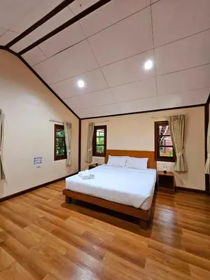 a bedroom with a large bed in a room at Samran Resort in Chalong