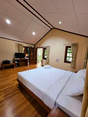 a large bedroom with a large white bed at Samran Resort in Chalong