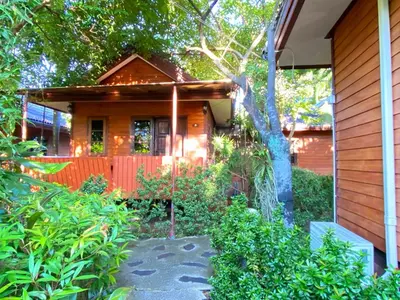 a house with a garden in front of it at Samran Resort in Chalong