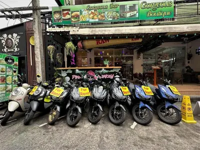 a row of motorcycles parked in front of a store at Gorgeous Boutique Room in Patong Beach
