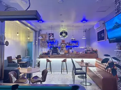 a restaurant with tables and chairs and a bar at Gorgeous Boutique Room in Patong Beach