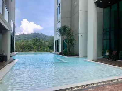 a swimming pool in the middle of a building at The Viva Patong A1 in Patong Beach