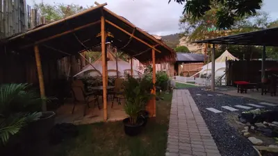 a gazebo with a table and chairs under it at Bambus Restaurant, Bar & Glamping in Patong Beach