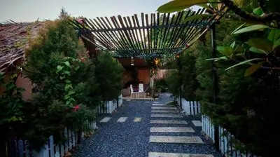a garden with a pathway with trees and a fence at Bambus Restaurant, Bar & Glamping in Patong Beach