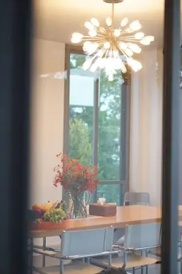 a dining room table with a vase of flowers on it at 4bedroom Villa Siray Beach Front in Phuket Town