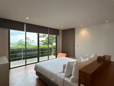 a bedroom with a large bed and a large window at 4bedroom Villa Siray Beach Front in Phuket Town