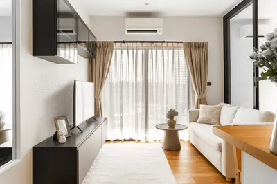 a living room with a white couch and a window at Title Halo Tenderness Naiyang Pool View Gym in Nai Yang Beach