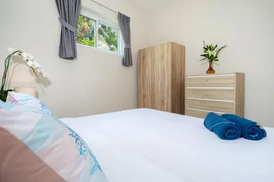 a bedroom with a white bed and a dresser at 1 Bedroom Villa in Rawai - v19 t in Ban Saiyuan (1)