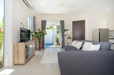 a living room with a blue couch and a tv at 1 Bedroom Villa in Rawai - v19 t in Ban Saiyuan (1)