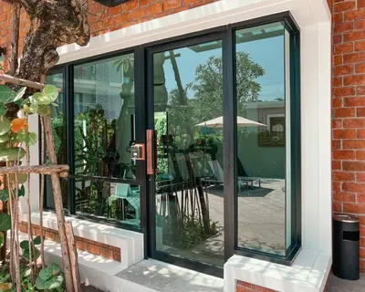 a sliding glass door with a patio in the background at Title V Summer Dream Pool View Gym Hammam in Rawai Beach