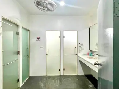 a bathroom with green and white walls and a sink at The Thai Guesthouse and Hostel in Patong Beach