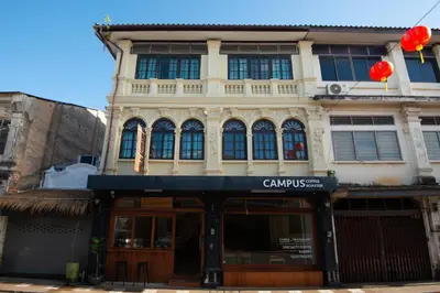 a building with red balloons in front of it at The Rommanee Classic Guesthouse in Phuket Town