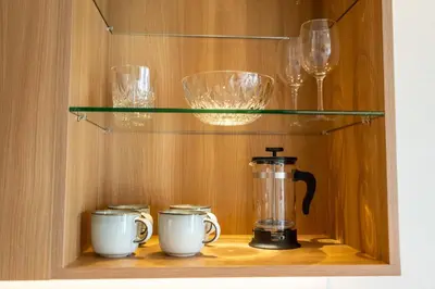 a cupboard with a blender and glasses on a shelf at Laguna Lakeside apartments with panoramic view in Bang Tao Beach