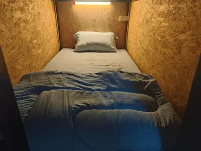 a small bed in a small room at Phuket Inn Patong Hub in Patong Beach
