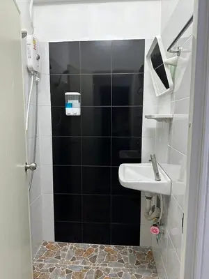a small bathroom with a sink and a shower at Phuket Inn Patong Hub in Patong Beach