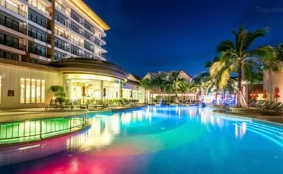 a large swimming pool in front of a building at Kata Beach Guesthouse-The Beach Condo in Kata Beach
