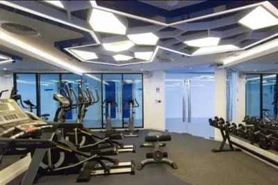 a gym with exercise equipment in a building at Kata Beach Guesthouse-The Beach Condo in Kata Beach