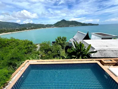 a swimming pool with a view of the ocean at Moonlight Panorama Seaview House by RESAVA in Surin Beach