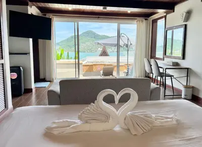 two white swans making a heart on a bed at Moonlight Panorama Seaview House by RESAVA in Surin Beach