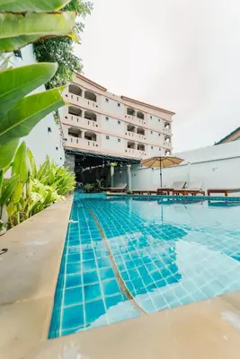 a swimming pool with a hotel in the background at Saiyuan Residence Phuket in Rawai Beach