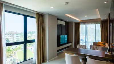 a room with a dining table and a large window at Apartment 2 bedrooms on Surin in Surin Beach