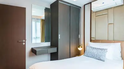 a bedroom with a bed and a mirror at Apartment 2 bedrooms on Surin in Surin Beach