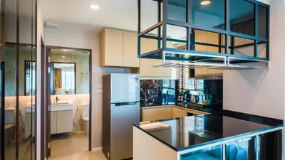 a kitchen with a refrigerator and a counter top at Apartment 2 bedrooms on Surin in Surin Beach
