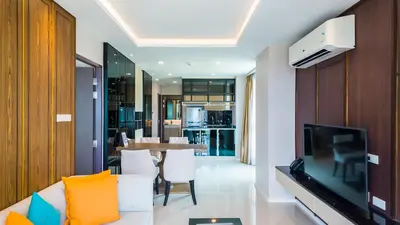 a living room with a white couch and a television at Apartment 2 bedrooms on Surin in Surin Beach