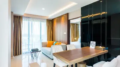 a living room with a table and a couch at Apartment 2 bedrooms on Surin in Surin Beach