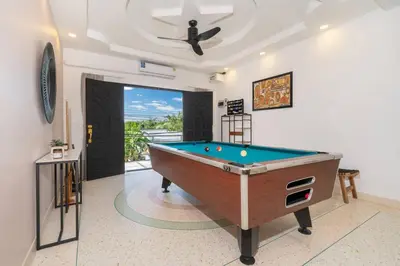a pool table in a living room with a ceiling at Golden Sands Villa only 15 minutes walk to beach in Surin Beach