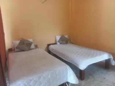 two beds in a room with white sheets at Salika Hostel Patong Phuket in Patong Beach