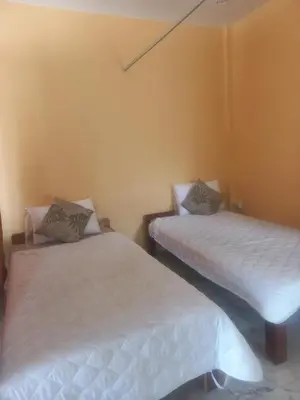 two beds in a room with white sheets at Salika Hostel Patong Phuket in Patong Beach