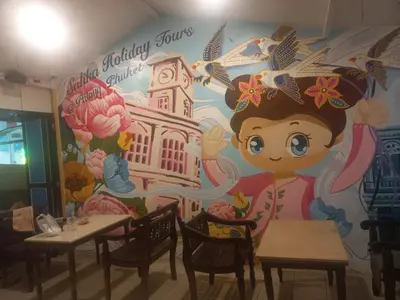 a mural of a girl in a restaurant with tables at Salika Hostel Patong Phuket in Patong Beach