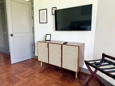 a living room with a flat screen tv on a wall at Allamanda Laguna Phuket 2 bedroom apartment Bang Tao Beach in Laguna Phuket