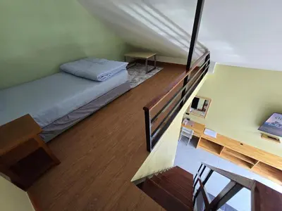 a small bedroom with a bed and a desk at Khumkatang Resort & Restaurant in Ban Bang Rong