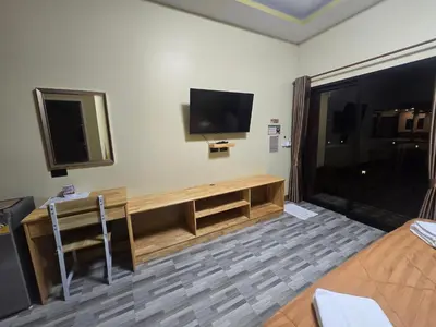 a room with a flat screen tv on the wall at Khumkatang Resort & Restaurant in Ban Bang Rong