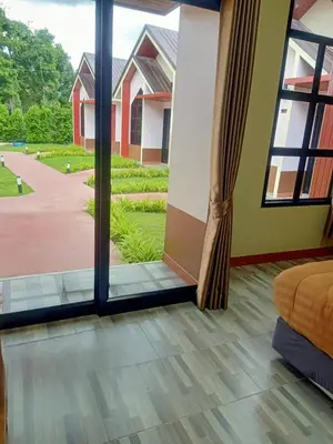 a room with a sliding glass door with a view of a yard at Khumkatang Resort & Restaurant in Ban Bang Rong