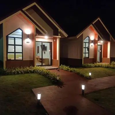 a house with lights in front of it at night at Khumkatang Resort & Restaurant in Ban Bang Rong