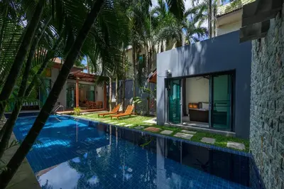 a swimming pool in front of a house with palm trees at Villa Laut 3BR Private Pool 10 min to Nai Harn in Rawai Beach
