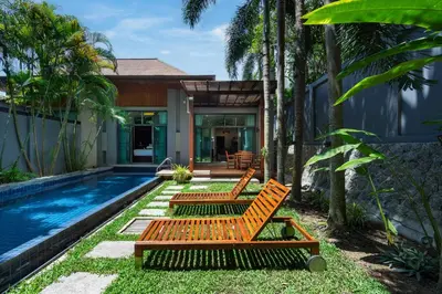 a house with a swimming pool and two orange benches at Villa Laut 3BR Private Pool 10 min to Nai Harn in Rawai Beach