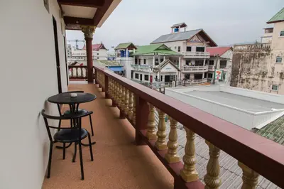 a balcony with a stool and a view of a city at Paripas Express Patong in Patong Beach