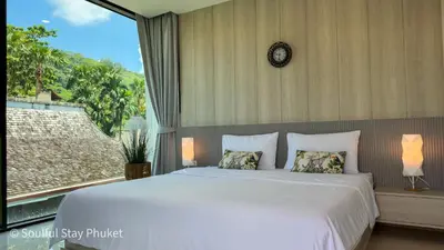 a bedroom with a large bed and a large window at Soulful Stay Phuket -Distant Seaview and Mountain View Retreat, Patong in Patong Beach
