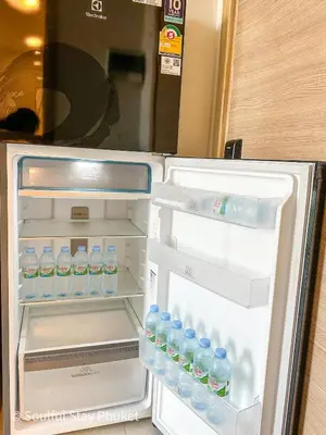 an open refrigerator filled with bottles of water at Soulful Stay Phuket -Distant Seaview and Mountain View Retreat, Patong in Patong Beach