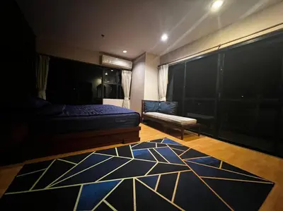 a bedroom with a bed and a rug on the floor at Patong Tower Apartment - AMP in Patong Beach