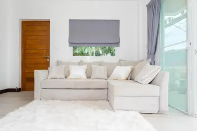 a white couch in a living room with a window at Apartment 1 Bedroom in Naiharn t in Ban Saiyuan (1)
