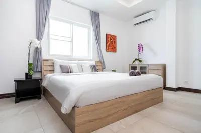 a bedroom with a large bed with a window at Apartment 1 Bedroom in Naiharn t in Ban Saiyuan (1)