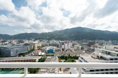 a view of a city with a mountain in the background at 1 Bedroom Brandnew Apartment in Patong Tower t in Patong Beach