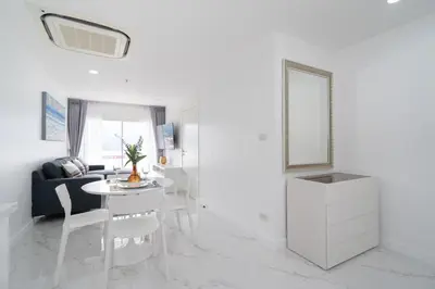 a living room with a table and a mirror at 1 Bedroom Brandnew Apartment in Patong Tower t in Patong Beach