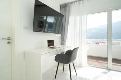 a white desk with a chair next to a window at 1 Bedroom Brandnew Apartment in Patong Tower t in Patong Beach